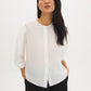 Button-front blouse in snow white with tie cuffs and pleated sleeves by Suzy Shier.