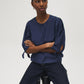 Button-front blouse in snow white with tie cuffs and pleated sleeves by Suzy Shier.