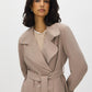 Belted trench coat in khaki grey with double-breasted closure and notch collar by Suzy.