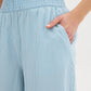 Light Wash Stripe Denim Tencel Gaucho Pant - Woman Wearing Wide-Leg Pants with Smocked Waistband - Suzy Shier