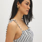 Snow White Black Stripe Empire Waist Midi Dress - Woman Wearing Striped Dress with Ruffle Hem - Suzy Shier