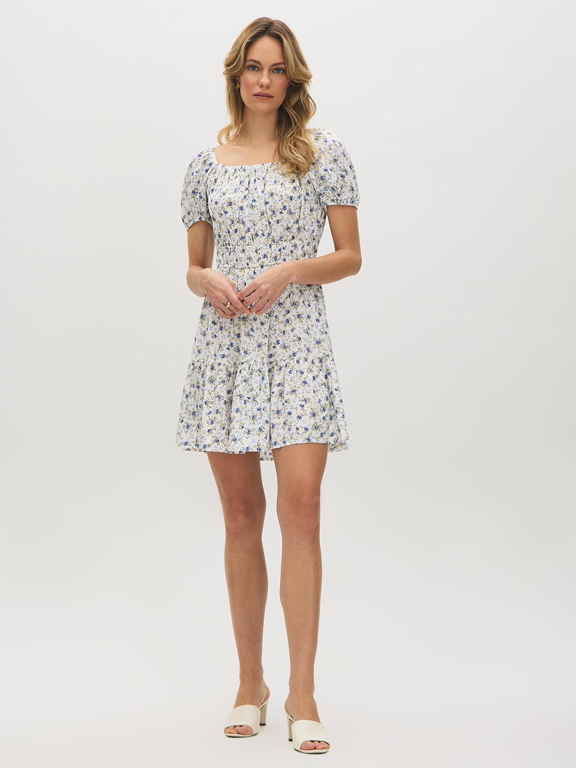 Snow White Ditsy Print Mini Dress - Woman Wearing Off-the-Shoulder Tiered Dress - Suzy Shier