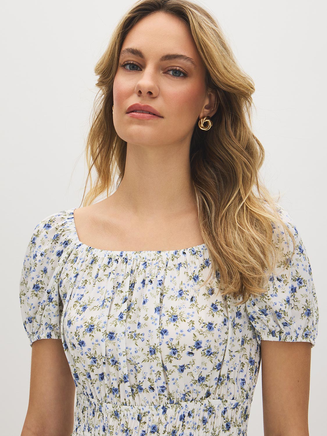 Snow White Ditsy Print Mini Dress - Woman Wearing Off-the-Shoulder Tiered Dress - Suzy Shier
