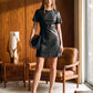 Jet Black Mini Faux Leather Dress with Belted Waist - Woman Wearing Short Sleeve Dress - Suzy Shier