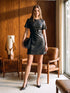 Jet Black Mini Faux Leather Dress with Belted Waist - Woman Wearing Short Sleeve Dress - Suzy Shier