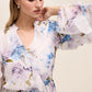 Floral peplum blouse with ruffle details and elasticized waist by Le Chateau.