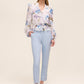 Floral peplum blouse with ruffle details and elasticized waist by Le Chateau.