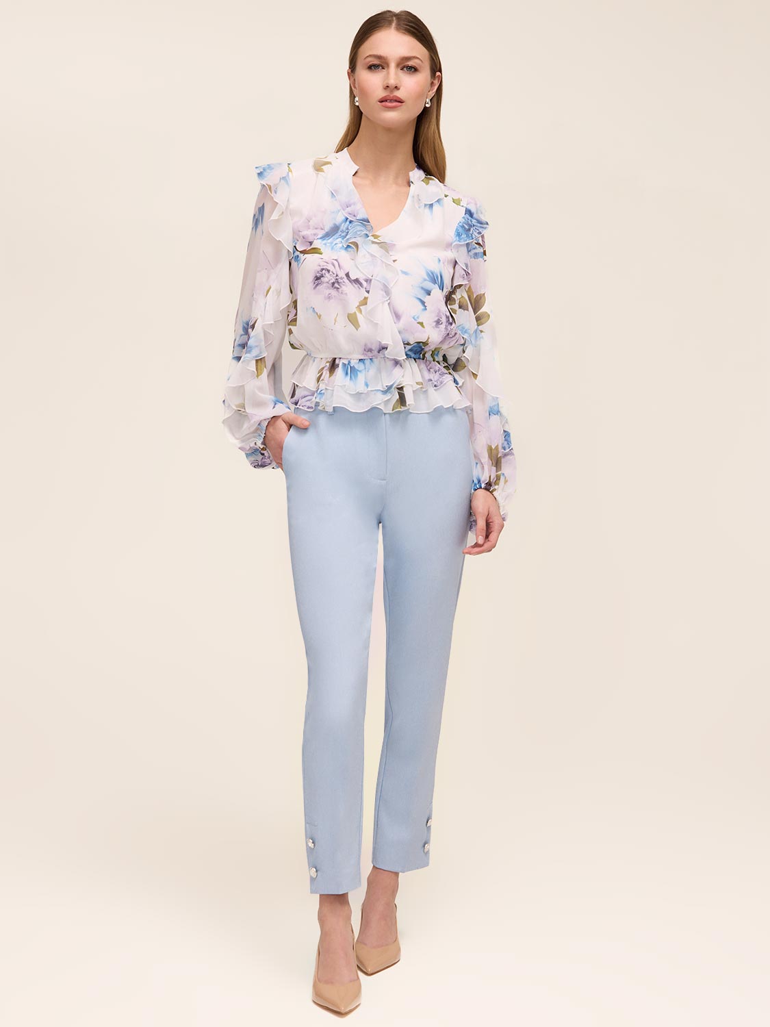 Floral peplum blouse with ruffle details and elasticized waist by Le Chateau.
