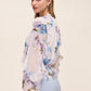 Floral peplum blouse with ruffle details and elasticized waist by Le Chateau.