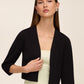 Knit crepe bolero with 3/4 sleeves and open-front design by Le Chateau.