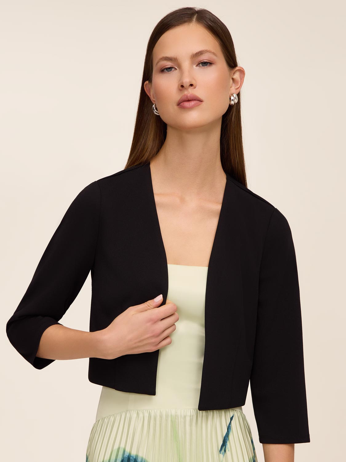 Knit crepe bolero with 3/4 sleeves and open-front design by Le Chateau.