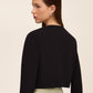 Knit crepe bolero with 3/4 sleeves and open-front design by Le Chateau.