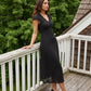Black/White Dot Satin Midi Dress with Lace Trim - Woman Wearing Elegant Polka Dot Dress - Suzy Shier