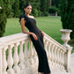 Black One-Shoulder Jumpsuit with Chiffon Ruffle Detail - Woman Wearing Wide-Leg Evening Jumpsuit - Le Chateau