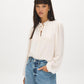 Winter White Swiss Dot Blouse with Peplum Hem - Woman Wearing Ruffle Tie Neck Blouse - Suzy Shier