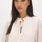Winter White Swiss Dot Blouse with Peplum Hem - Close-up Fabric Detail - Suzy Shier