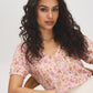 Peach Dust Floral Crinkle V-Neck Top - Seated Front View - Suzy Shier