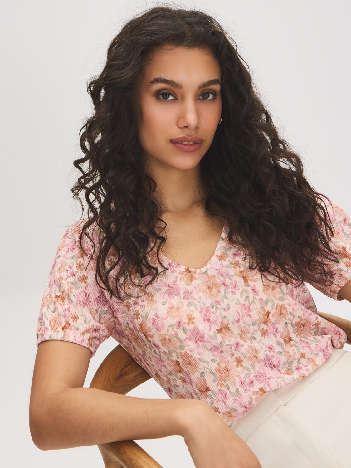 Peach Dust Floral Crinkle V-Neck Top - Seated Front View - Suzy Shier